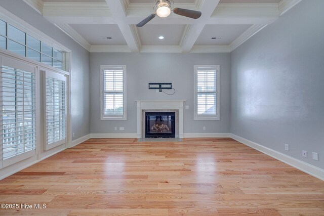 unfurnished living room featuring coffered ceiling, crown molding, beamed ceiling, ceiling fan, and light hardwood / wood-style floors