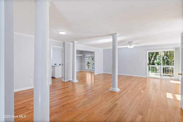 unfurnished living room with ceiling fan, a healthy amount of sunlight, decorative columns, and light hardwood / wood-style flooring