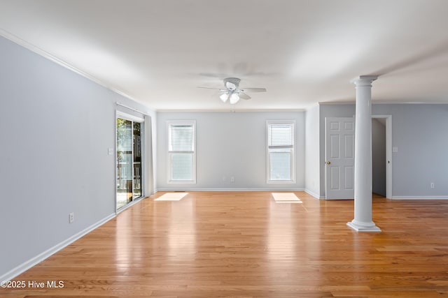 unfurnished living room with decorative columns, light hardwood / wood-style floors, and a healthy amount of sunlight