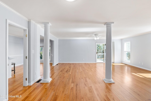 unfurnished room featuring crown molding, light hardwood / wood-style floors, ceiling fan, and ornate columns