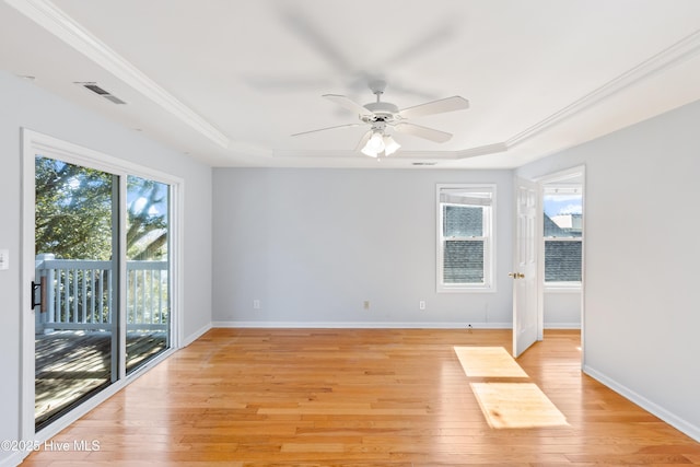 unfurnished room with light hardwood / wood-style flooring, ornamental molding, and a raised ceiling