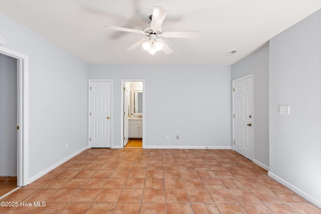 tiled empty room with ceiling fan