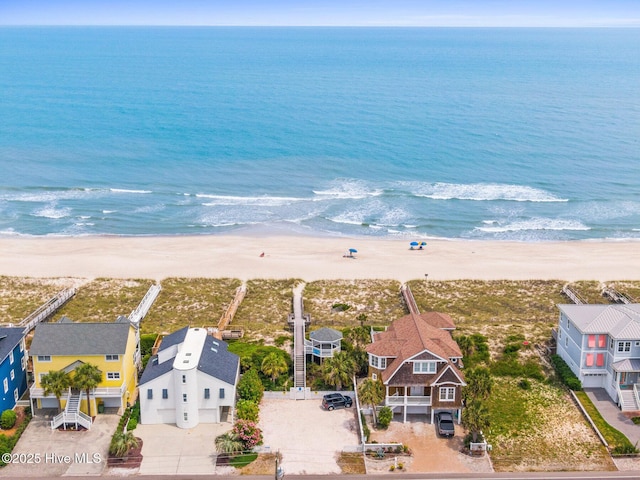 bird's eye view with a water view and a beach view