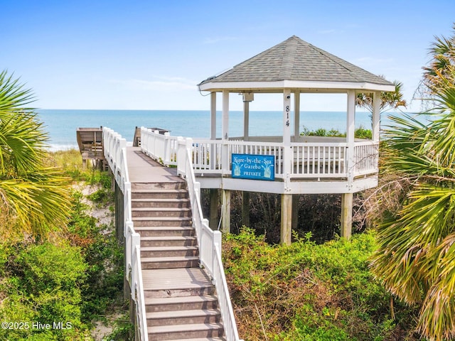 view of dock featuring a gazebo and a water view