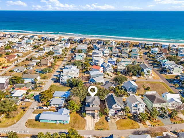 drone / aerial view with a beach view and a water view