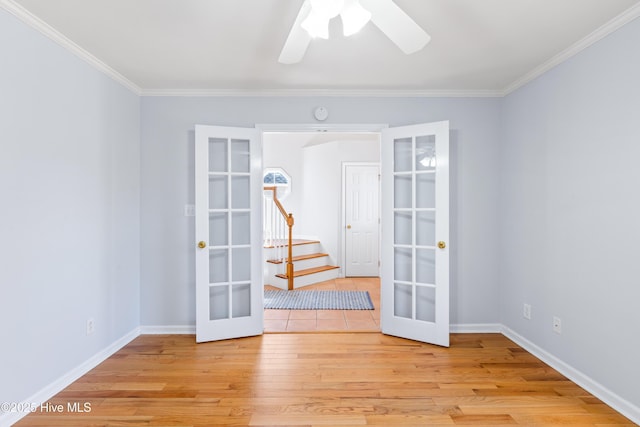 spare room featuring french doors, ceiling fan, ornamental molding, and light wood-type flooring