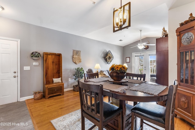 dining space featuring lofted ceiling and light hardwood / wood-style floors