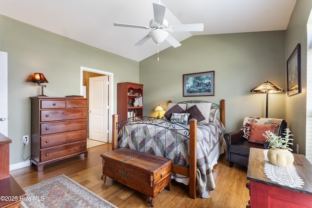 bedroom with ceiling fan, vaulted ceiling, and wood-type flooring