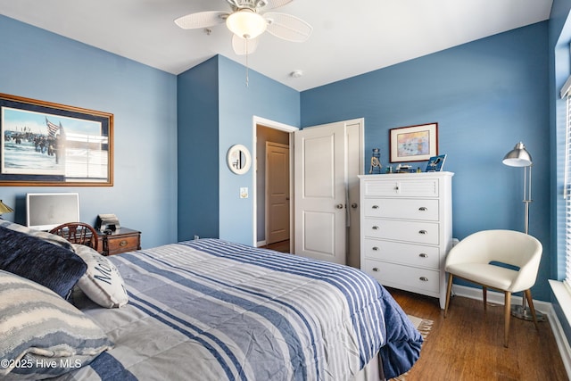 bedroom with dark hardwood / wood-style floors and ceiling fan