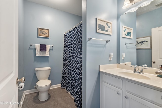 bathroom featuring tile patterned flooring, vanity, walk in shower, and toilet