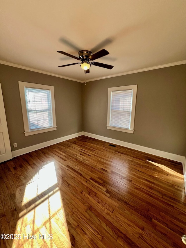 spare room with ceiling fan, ornamental molding, and dark hardwood / wood-style flooring