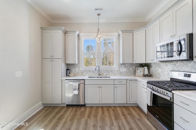 kitchen featuring stainless steel appliances, sink, and white cabinets