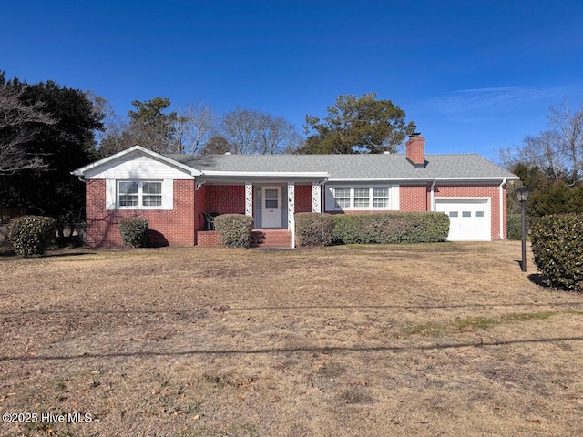 single story home featuring a garage and a front yard