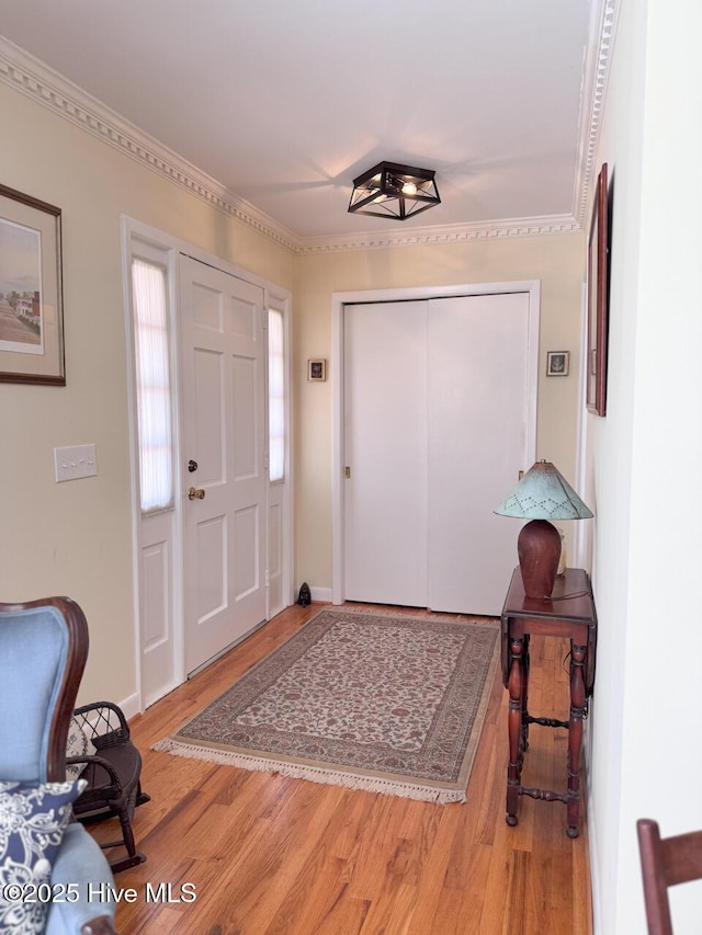 foyer entrance featuring crown molding and wood-type flooring