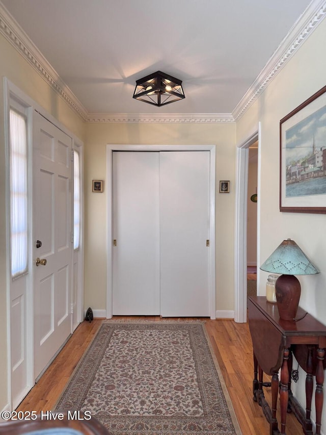 entryway featuring hardwood / wood-style flooring and ornamental molding