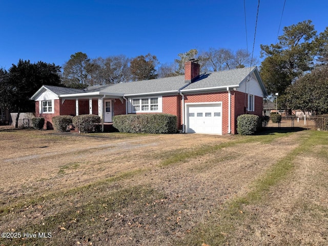 single story home with a garage and a front lawn