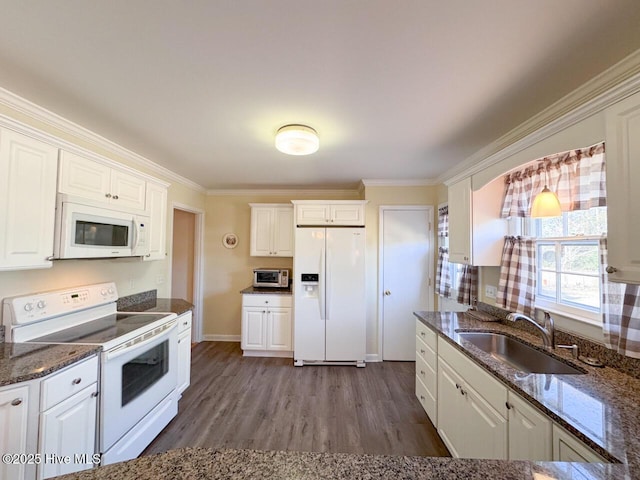 kitchen featuring sink, white cabinetry, crown molding, white appliances, and dark stone counters