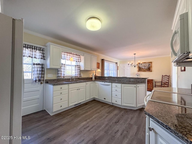 kitchen with white cabinetry, sink, kitchen peninsula, crown molding, and white appliances