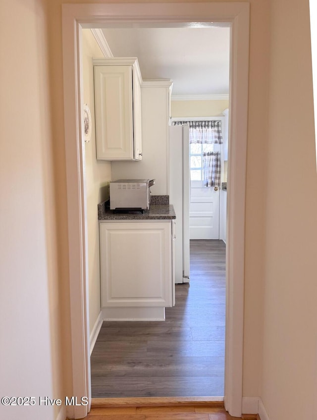 hall with crown molding and hardwood / wood-style floors