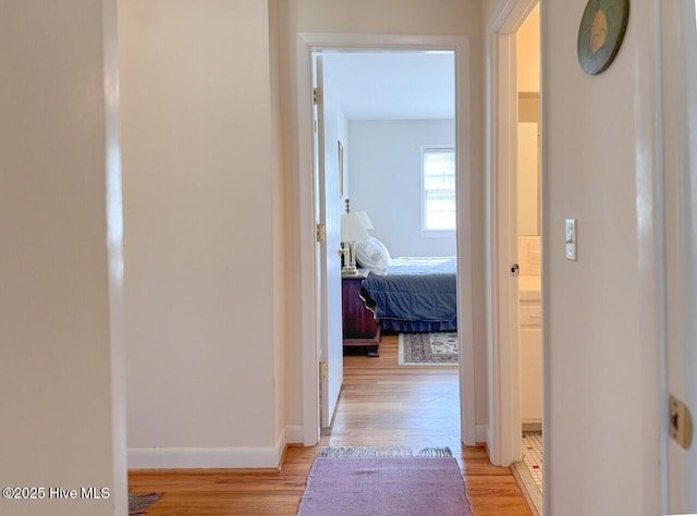 corridor with light hardwood / wood-style floors