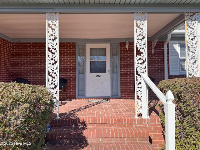 view of exterior entry featuring a porch