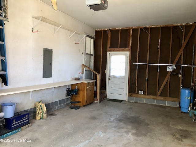 garage with a garage door opener and electric panel