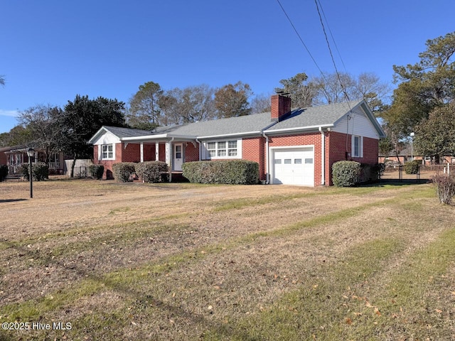 ranch-style house featuring a garage and a front lawn