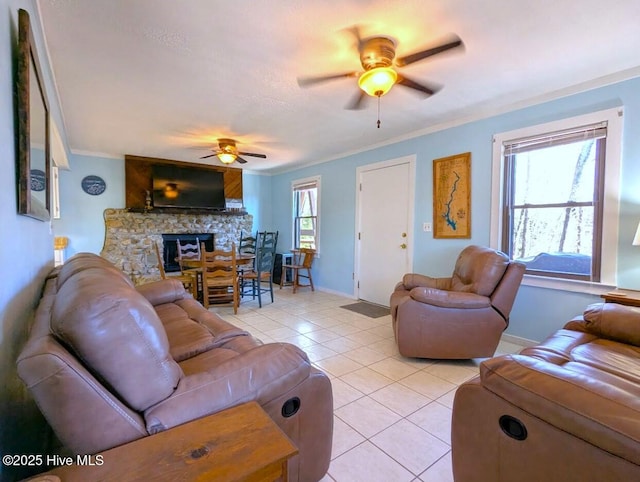 tiled living room with a fireplace, ornamental molding, and ceiling fan