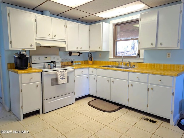 kitchen featuring white cabinetry, a paneled ceiling, sink, and electric range