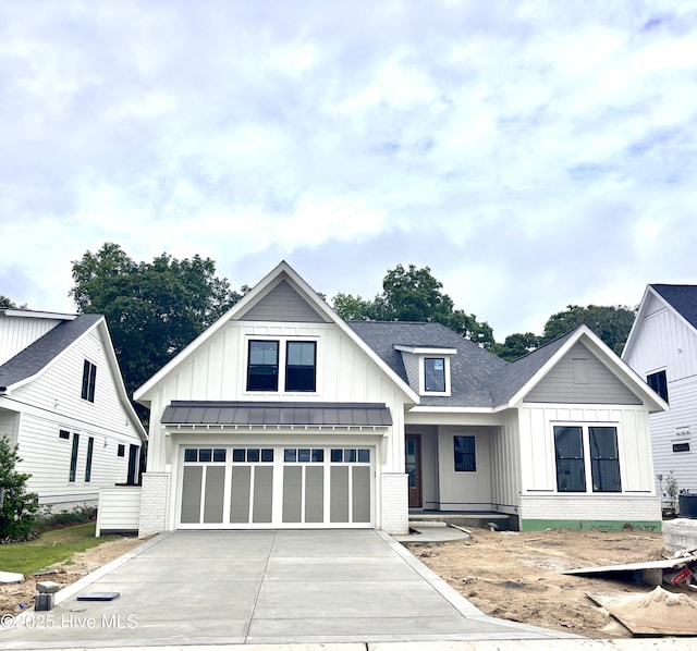 8257 Winding Creek Cir, Wilmington, NC 28411 - modern inspired farmhouse with brick siding, board and batten siding, driveway, and a standing seam roof