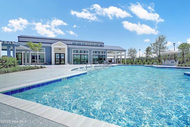 community pool with a patio and a pergola