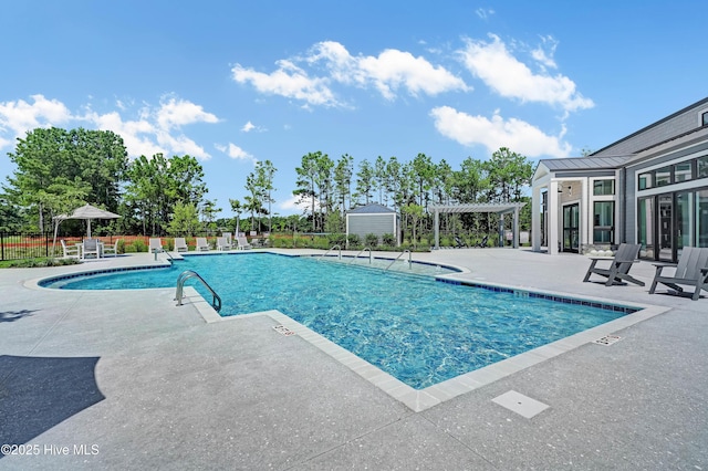 community pool featuring a patio area, fence, and a pergola