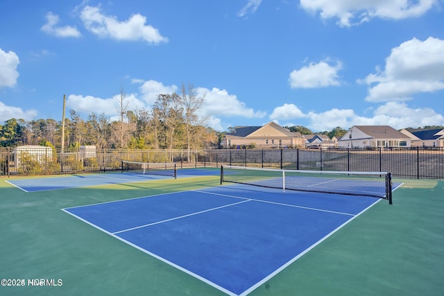 view of sport court with fence