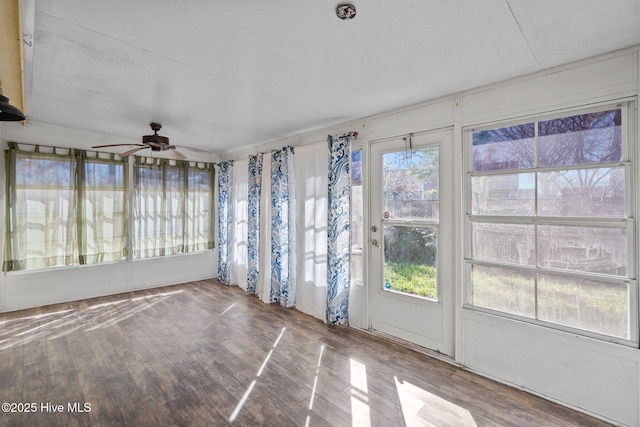 unfurnished sunroom featuring a wealth of natural light and ceiling fan