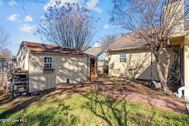 back of property with a storage shed