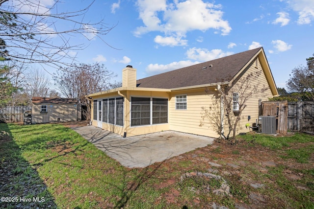 back of property with central AC, a patio, a sunroom, and a lawn