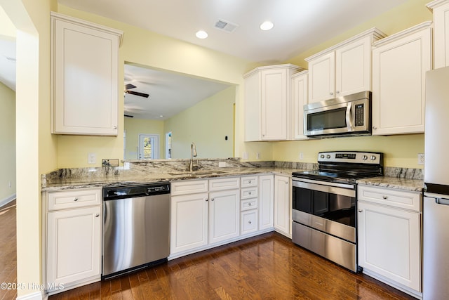 kitchen with sink, ceiling fan, white cabinets, and appliances with stainless steel finishes