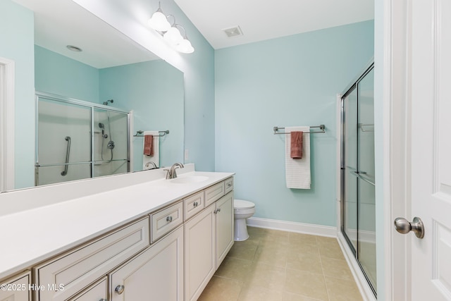 bathroom featuring vanity, tile patterned flooring, toilet, and walk in shower