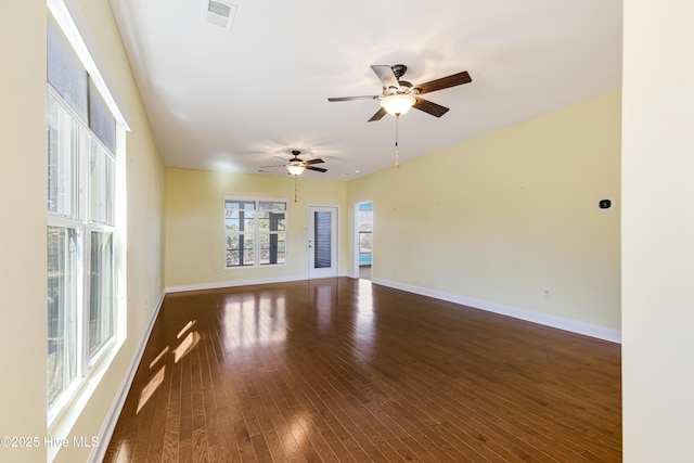 unfurnished room with dark wood-type flooring and ceiling fan