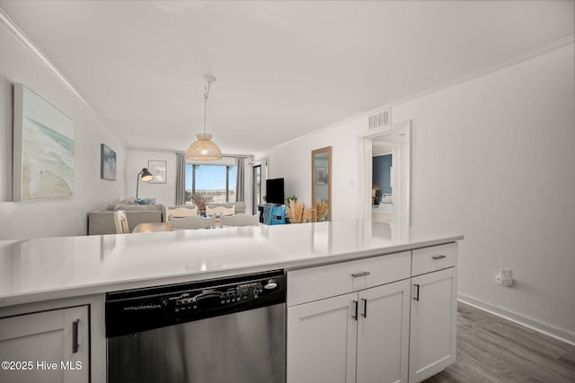 kitchen featuring decorative light fixtures, light countertops, ornamental molding, white cabinets, and dishwasher