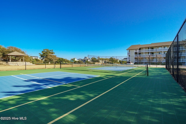 view of sport court with fence and a gazebo