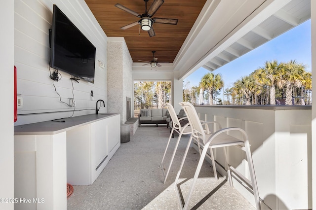 view of patio with an outdoor hangout area, ceiling fan, and an outdoor wet bar