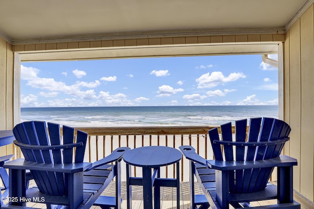 balcony with a view of the beach and a water view