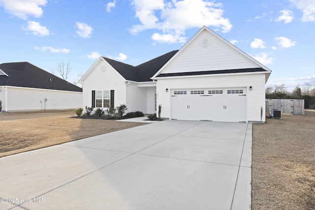 view of front facade featuring a garage, central AC, and a front yard