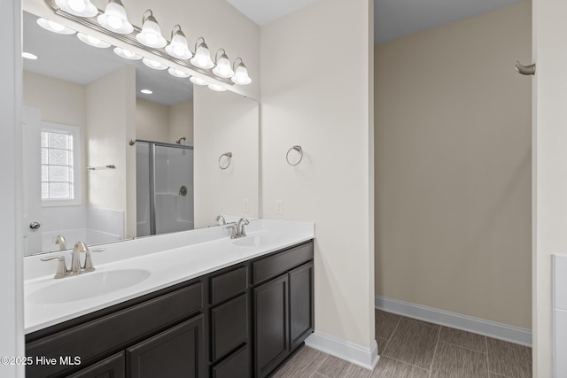 bathroom with vanity and a shower with shower door