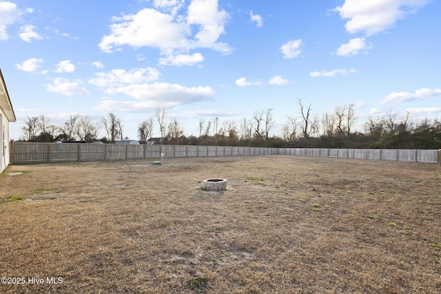 view of yard featuring an outdoor fire pit