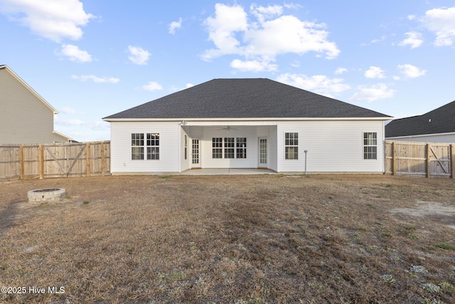 rear view of property featuring ceiling fan and a patio area