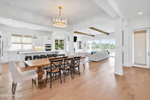 740 Waterstone Dr, Wilmington, NC 28411 - dining space featuring decorative columns, light wood-style floors, crown molding, and recessed lighting
