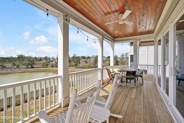 740 Waterstone Dr, Wilmington, NC 28411 - deck featuring a water view, outdoor dining space, and a ceiling fan