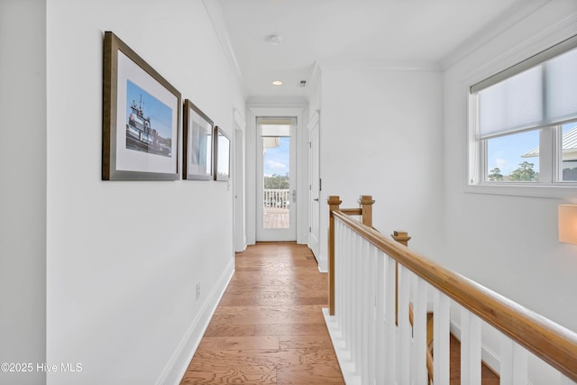 740 Waterstone Dr, Wilmington, NC 28411 - hall with an upstairs landing, light wood finished floors, ornamental molding, baseboards, and recessed lighting